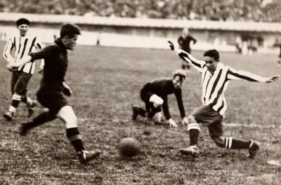 Action from the match between Belgium and Paraguay (striped shirts).