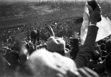 The crowd is seen cheering in stands as the Uruguayan World Champions parade on the pitch after defeating Argentina. Photo taken from stands by a spectator.