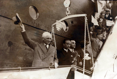 FIFA President Jules Rimet greets the crowd while disembarking the SS Conte Verde. In the back we can see members of the French team waving Uruguayan flags.