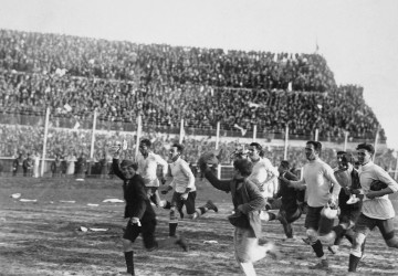 The Urguayan team are joined by some young boys as they enjoy a triumphant lap of honour after defeating Argentina.