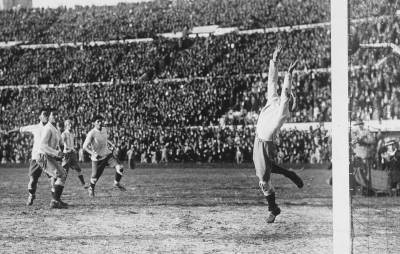 Uruguayan striker Hector Castro scores his sides fourth goal past Argentine keeper Juan Botasso.