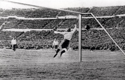 Argentine goalkeeper Juan Botassodives in vain in an attempt to stop Uruguay's third goal of the Final, scored by Santos Iriarte.