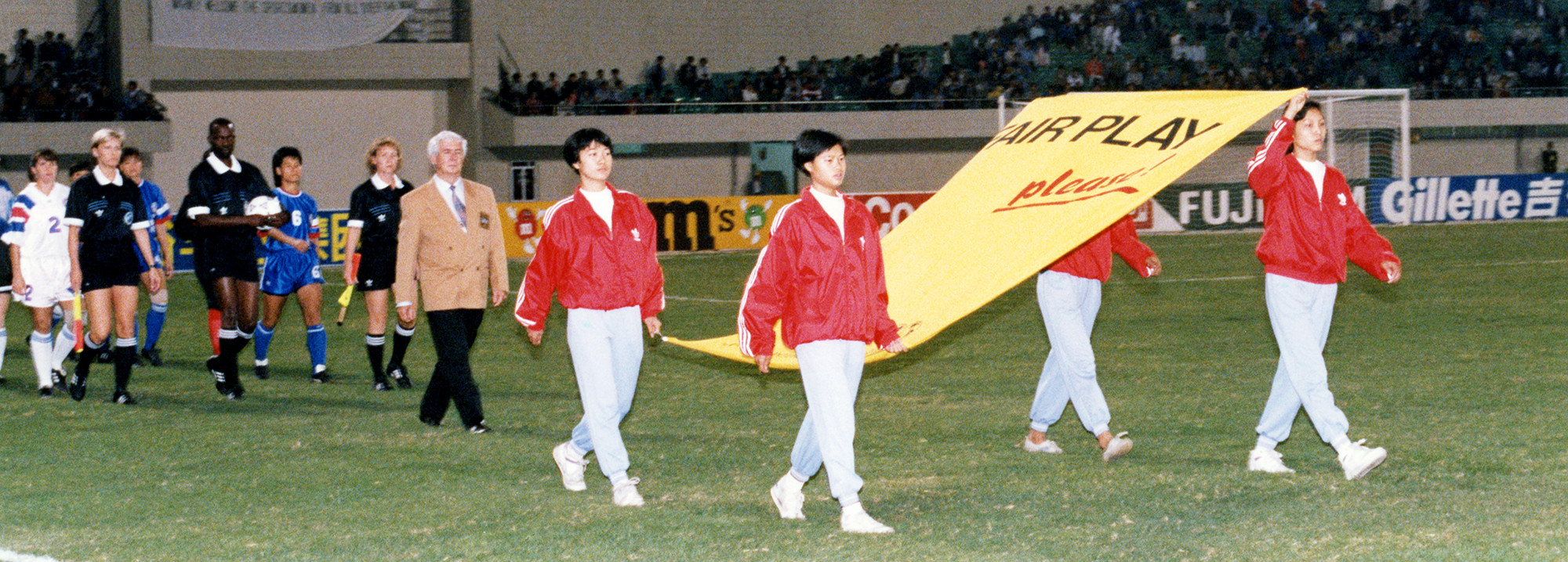 Players and referees enter the pitch prior to the quarter-final between USA and Chinese Taipei, in Foshan.